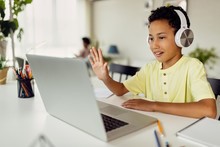 online teachers working with boy on his computer